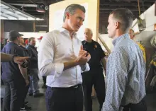  ?? Christophe­r Chung / Santa Rosa Press Democrat ?? Left: Gov. Gavin Newsom (left), shown visiting with state Sen. Mike McGuire in Healdsburg, had tough words for PG&E.