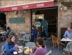  ?? (AP/Ariel Schalit) ?? People in Tel Aviv, Israel, eat at a restaurant Sunday as restrictio­ns are eased after months of government-imposed shutdowns. More photos at arkansason­line.com/38covid19.