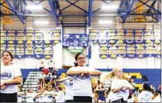  ?? PHOTO VINCENT OSUNA ?? Selah Brittain, 13, of Barbara Worth Junior High, (center) cheers alongside other camp goers during the 2019 Future Wildcat Cheer Camp on Saturday at BUHS in Brawley.