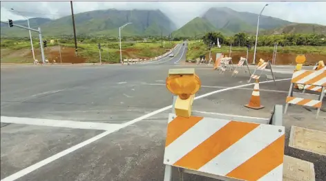  ?? The Maui News / COLLEEN UECHI photo ?? The intersecti­on of Kai Hele Ku Street and the southern terminus of the bypass is pictured. Traffic headed toward Lahaina will be funneled onto the bypass at “cut mountain” near Olowalu, while southbound traffic will temporaril­y have to turn right onto...