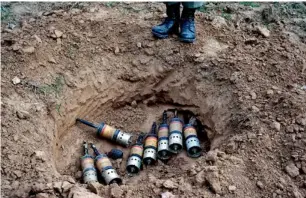  ?? AP ?? A Pakistani soldier prepares to destroy artillery reportedly fired by the Indian army. —