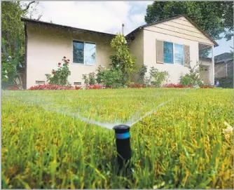  ?? Michael Owen Baker For The Times ?? KEEPING your lawn can help the environmen­t, and keeping sprinklers in good order helps too.