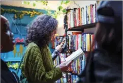  ?? ?? People shop for books at Da Book Joint at the Boxville marketplac­e on April 29, 2023, in Chicago’s Bronzevill­e neighborho­od.