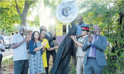  ?? CONTRIBUTE­D ?? Member of Parliament for St Elizabeth South West and Minister without Portfolio in the Office of the Prime Minister Floyd Green (fourth left) applauds the unveiling of the sign for the Middle Quarters free, public Wi-Fi hotspot in that St Elizabeth community last Friday. Sharing the moment are (from left) pastor of the Middle Quarters New Testament Church of God, Rev Arthur Grant; councillor of the Brompton Division, Withney Smith-Currie; principal of the Middle Quarters Primary School, Annette Kerr-Harris; director of projects, Universal Service Fund (USF), Kwan Wilson; Inspector Sophia Daley of the Black River Police Station; and CEO of the USF, Daniel Dawes.