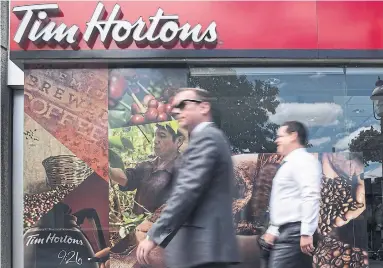  ?? EDUARDO LIMA/THE CANADIAN PRESS FILE PHOTO ?? RBI has been feuding with a group of Tim Hortons franchise owners over cost-cutting measures and cash register outages.