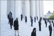  ?? ALEX BRANDON — THE ASSOCIATED PRESS ?? Former law clerks for Justice Ruth Bader Ginsburg stand on the steps of the Supreme Court as they await the arrival of the casket of Ginsburg to arrive at the Supreme Court in Washington on Wednesday.