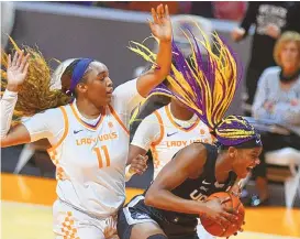  ?? SAUL YOUNG/KNOXVILLE NEWS SENTINEL VIA AP ?? UConn’s Aaliyah Edwards, right, fights off defensive pressure from Tennessee’s Kasiyahna Kushkituah (11) during their game Thursday in Knoxville, Tenn., in a battle between ranked teams. The Huskies won to remain unbeaten.