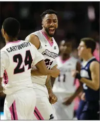  ?? AP/STEPHAN SAVOIA ?? Providence’s Jalen Lindsey (center) celebrates with Kyron Cartwright after the Friars’ 76-71 victory Wednesday night over No. 2 Villanova in Providence, R.I.