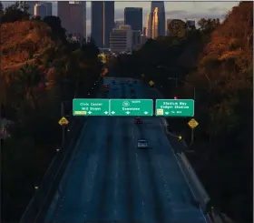  ?? (The New York Times/David Walter Banks) ?? Morning rush-hour traffic is scant Thursday on Route 110 near downtown Los Angeles as California’s strict coronaviru­s restrictio­ns keep most residents under lockdown.