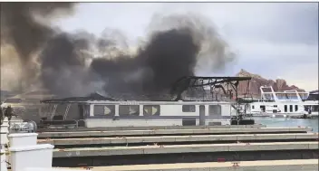  ?? ROBERT WILKES VIA AP ?? THIS PHOTO PROVIDED BY ROBERT WILKES, owner of a house boat management company, shows smoke rising from a fire on Friday at Wahweap Marina on Lake Powell near Page, Nev.