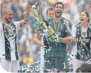  ??  ?? Gianluigi Buffon (Juventus) lifts the Serie A trophy in his last match for the club as he celebrates winning the championsh­ip with team-mates