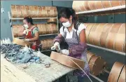  ?? ZHAO YONGZHANG / FOR CHINA DAILY ?? Workers make guitars in a manufactur­ing plant in Zheng’an county, Southwest China’s Guizhou province.