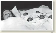  ?? AP ?? ■ Elzire Dionne with her five girls shortly after their birth.