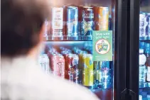  ??  ?? A VENDING MACHINE signage encouragin­g consumers to limit touching of products is seen at Canteen’s headquarte­rs in Charlotte, North Carolina.