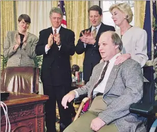  ?? Associated Press ?? BRADY HANDGUN VIOLENCE PREVENTION ACT OF 1993 Sarah Brady, right, said President Bill Clinton’s signing of the bill was “the proudest moment of our lives.” From left, Atty. Gen. Janet Reno, Clinton, Vice President Al Gore and Jim Brady.