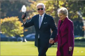  ?? EVAN VUCCI/ASSOCIATED PRESS ?? President Joe Biden and first lady Jill Biden arrive on the South Lawn of the White House after spending the weekend in Rehoboth Beach, Del., Monday in Washington. Biden is planning trips across the U.S. to speak about the impacts of the new $1 trillion infrastruc­ture deal.