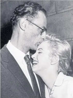  ?? ?? Marilyn Monroe leans against her then-fiance, playwright Arthur Miller, as he kisses her at her New York apartment on June 22, 1956. The couple had a four-month honeymoon in the U.K., the focus of Michelle Morgan’s book “When Marilyn Met The Queen.”