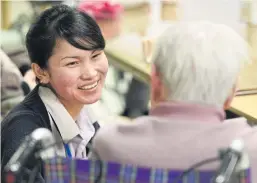  ?? ?? Indonesian nurse Dewi Ningsih Naibaho talks to an elderly woman at a nursing home in Futtsu, in eastern Tokyo. Japan has become more open to foreign workers to care for its large elderly population.