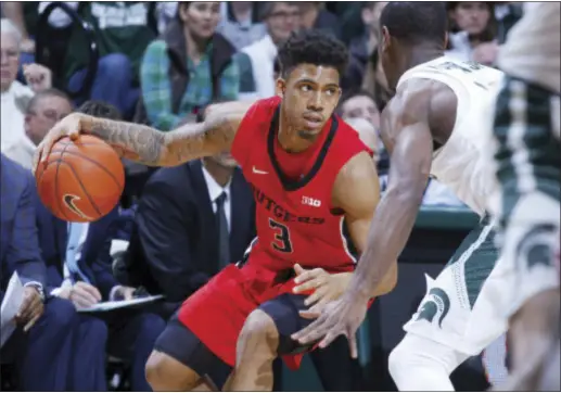  ?? THE ASSOCIATED PRESS ?? Rutgers’ Corey Sanders (3) drives against Michigan State’s Tum Tum Nairn, right, during the first half.