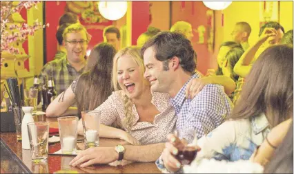  ?? AP PHOTO ?? This photo provided by Universal Pictures shows, Amy Schumer , left, as Amy, and Bill Hader as Aaron, on a date in “Trainwreck,” the new comedy from director/producer Judd Apatow.