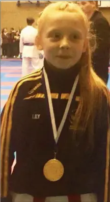  ??  ?? Lily Sheeran pictured with her gold medal from the North v South Open Championsh­ips. See story in Club Briefs.