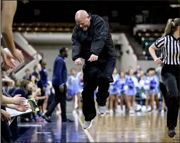  ?? AARON ONTIVEROZ — THE DENVER POST ?? D’evelyn head coach Chris Olson goes bananas as his team closes out against Riverdale Ridge during the second half of D’evelyn’s 54-47 win in a Great 8 tournament showdown at the Denver Coliseum on Friday.