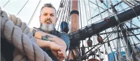  ??  ?? ON DECK: Australian National Maritime Museum marine archaeolog­ist James Hunter next to the replica Endeavour in Pyrmont, Sydney.