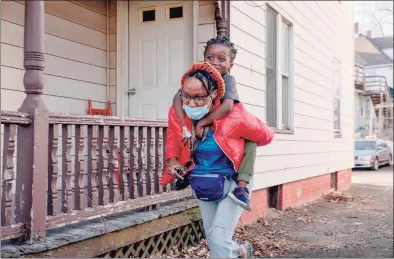  ?? Yehyun Kim / CTmirror.org ?? Moneisha Bryan runs with her youngest son, Myron Hodges Jr., 4, on her back. “Now I’m fine with not knowing,” Bryan said. “So now, [I’m] accepting myself and still working towards my goal. … That’s how I’m different after the pandemic.”