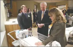  ?? The Sentinel-Record/ Richard Rasmussen ?? TOUR: CHI St. Vincent CEO Chad Aduddell, left, and Gov. Asa Hutchinson tour the new CHI St. Vincent Hot Springs Anthony Childbirth Center with Marsha Oliver, nurse manager for women’s services, on Monday.