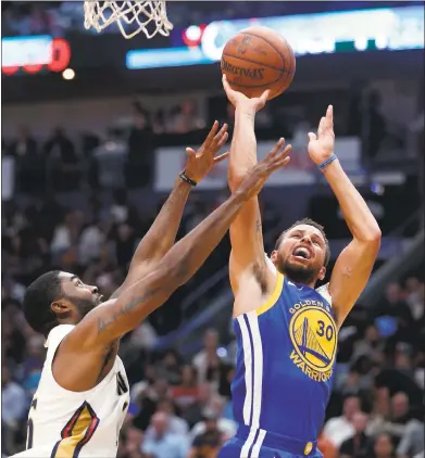  ?? PHOTOS BY GERALD HERBERT — ASSOCIATED PRESS ?? Stephen Curry shoots over New Orleans’ E’Twaun Moore. Below, Curry later turned his right ankle and left the arena on crutches.