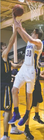  ?? Westside Eagle Observer/MIKE ECKELS ?? Ryan Ross (Decatur 30) puts up a reverse layup during the fourth quarter of the Decatur-Fayettevil­le Haas Hall conference matchup at Peterson Gym in Decatur Dec. 4. The Mastiffs barely beat out the Bulldogs to take the conference win, 49-45.