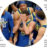  ?? ?? An emotional Stephen Curry, centre, celebrates the Warriors’ championsh­ip success with team-mates.