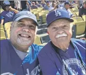  ??  ?? SEASON-TICKET HOLDER STAN BROOKS, left, attends opening day in 2018 with his father, Philip.