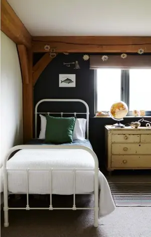  ??  ?? GABRIEL’S ROOM Farrow & Ball’s Down Pipe is a dramatic backdrop for an iron-framed bed