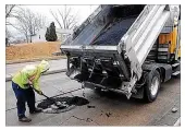  ?? MARSHALL GORBY / STAFF ?? A Dayton crew patches a pothole on Gettysburg Avenue. Local officials say potholes are worse this year than the past two winters.