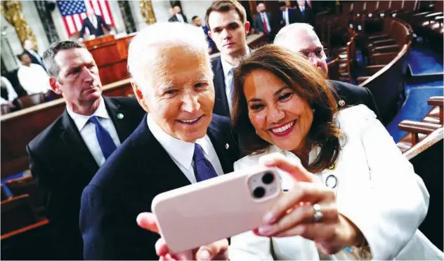  ?? Reuters ?? ↑
Joe Biden poses for a selfie with a supporter as he departs the US Capitol in Washington DC on Thursday.