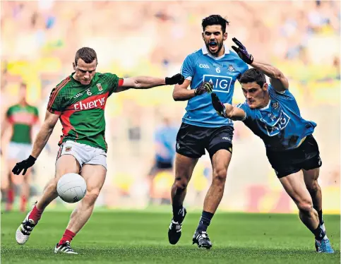  ??  ?? Pursuit of history: (main picture) Colm Boyle during last year’s final replay loss to Dublin, which left Mayo fans distraught (below); Paddy Pendergras­t (above right) is one of two surviving members from the last Mayo team to win the title, in 1951