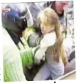  ??  ?? In bright spot in devastatin­g day, 10-year-old girl is saved by rescuers.