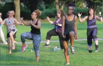  ?? MEDIANEWS GROUP FILE PHOTO ?? Fitness enthusiast­s dance with high knee movements during a Zumba class held outdoors at Memorial Park. Exercise reduces the risk of chronic disease and helps with promote overall health.
