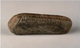  ?? Photograph: The Herbert Art Gallery and Museum ?? The ogham stone, 11cm long and weighing 139g, was found in an overgrown garden.