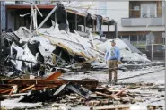  ?? MARK HUMPHREY - THE ASSOCIATED PRESS ?? A man looks over buildings destroyed by storms Tuesday, March 3, in Nashville, Tenn. Tornadoes ripped across Tennessee early Tuesday, shredding buildings and killing multiple people.
