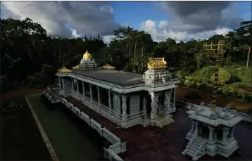  ?? PHOTOS BY JESSIE WARDARSKI — THE ASSOCIATED PRESS ?? The sun shines down on the golden spires of the Iraivan Temple at Kauai’s Hindu Monaster, on July 10in Kapaa, Hawaii. The temple is made entirely of hand-carved granite, which the monks have been constructi­ng for the last 33years. It was completed in March and marked with a special opening ceremony the same month.