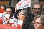  ?? Lea Suzuki / The Chronicle ?? PG&amp;E’s bankruptcy plans draw protests at a state Public Utilities Commission meeting last month.