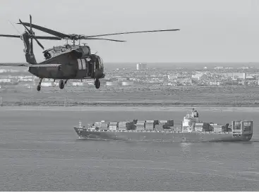  ?? Michael Ciaglo / Houston Chronicle file ?? An Army Black Hawk helicopter, carrying Army Corps of Engineers officials in 2016, flies over the Houston Ship Channel. A dike, also known as the coastal spine, is being proposed to protect Galveston, Bolivar and the Galveston Bay area from storm surges.