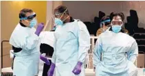  ?? MIKE STOCKER/SOUTH FLORIDA SUN SENTINEL ?? Health care workers prepare to open a COVID-19 testing site at the Koinonia Worship Center and Village in West Park on July 22.