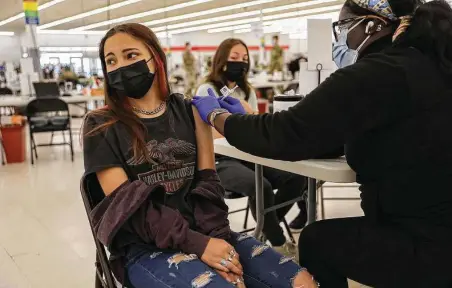  ?? Tribune News Service file photo ?? Luscia Castellano­s, 12, gets a Pfizer vaccinatio­n in May in Des Plaines, Ill. A new CDC report has found that the Pfizer vaccine’s efficacy at reducing the risk of hospitaliz­ation drops off significan­tly more than the Moderna vaccine after 120 days.