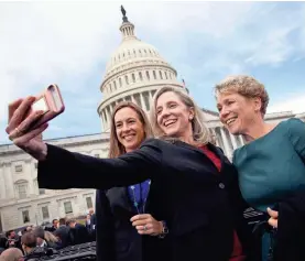  ?? WIN MCNAMEE/GETTY IMAGES ?? Newly elected Democratic members of the House Abigail Spanberger, center, Mikie Sherrill, left, and Chrissy Houlahan take a selfie.