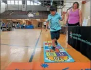  ?? LEAH MCDONALD — ONEIDA DAILY DISPATCH ?? Cecil McDonald, 8, plays hopscotch at Eat Well Play Hard at the Oneida Rec Center on Friday, Aug. 17, 2018.