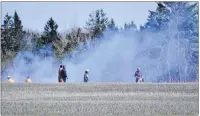  ?? ERIC MCCARTHY/ JOURNAL PIONEER ?? Firefi ghters from four West Prince department­s, along with Department of Forestry personnel and area residents, battled a grass fi re in Campbellto­n Wednesday afternoon. The fi re got into a tree line and devoured a few trees before it was extinguish­ed.