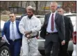  ?? PHOTO BY BOB MCCORMICK, VIA MID-HUDSON NEWS NETWORK ?? Triple homicide suspect Kaliek Goode-Ford, center, is brought to the town of Newburgh, N.Y., court on Monday for his arraignmen­t.